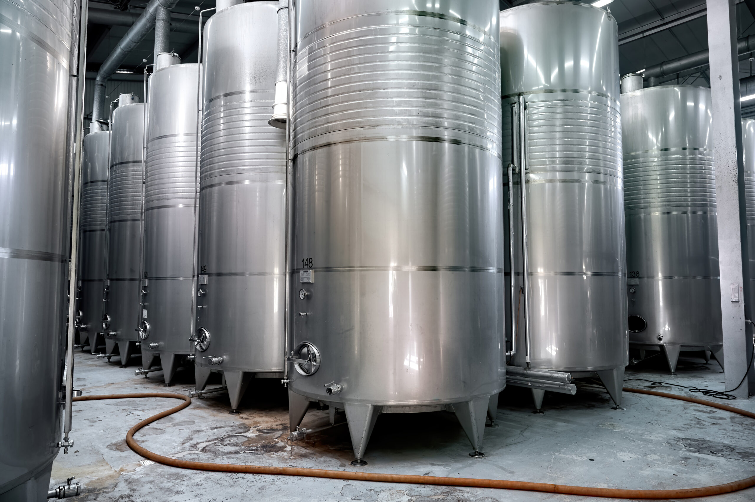 Rows of metal wine storage tanks located in Chateau Vartely, Orhei, Moldova